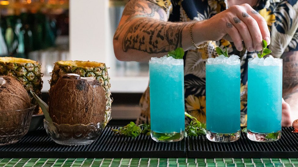 Bartender garnishing cocktails at the bar